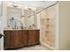 Elegant bathroom with dual vanities, decorative mirrors, and a beautifully tiled shower at 1960 Kansas Ne Ave, St Petersburg, FL 33703