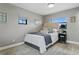 Cozy bedroom with two windows and textured wall; neutral color scheme and bed at 1960 Kansas Ne Ave, St Petersburg, FL 33703