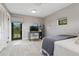 Bedroom features two windows, desk, and access to outdoor deck or patio at 1960 Kansas Ne Ave, St Petersburg, FL 33703