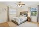 Comfortable bedroom featuring a ceiling fan, two windows with blinds, and a stylish bed at 1960 Kansas Ne Ave, St Petersburg, FL 33703