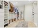 Large walk-in closet features custom shelving, plenty of storage, and neutral decor at 1960 Kansas Ne Ave, St Petersburg, FL 33703