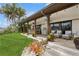 Inviting covered patio with comfortable seating and outdoor dining area overlooking the lush lawn and waterfront at 1960 Kansas Ne Ave, St Petersburg, FL 33703