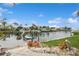 Dock with boat lift offering waterfront access and scenic views of the surrounding canal and neighborhood at 1960 Kansas Ne Ave, St Petersburg, FL 33703