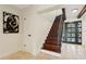 Staircase leads to front door featuring iron details; light travertine floor at 1960 Kansas Ne Ave, St Petersburg, FL 33703