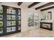 Bright foyer features travertine floors, an ornate front door, plantation shutters, and dark wood beams at 1960 Kansas Ne Ave, St Petersburg, FL 33703