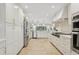 Spacious white kitchen features stainless steel appliances, ample cabinetry, and recessed lighting at 1960 Kansas Ne Ave, St Petersburg, FL 33703