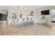 Bright eat-in kitchen featuring a large island with pendant lighting and sleek, white bar stools at 1960 Kansas Ne Ave, St Petersburg, FL 33703