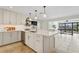 Modern kitchen island boasts white cabinets, marble countertop and stainless steel appliances at 1960 Kansas Ne Ave, St Petersburg, FL 33703
