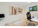 Clean office with travertine floors, modern desk and chair, and two art pieces at 1960 Kansas Ne Ave, St Petersburg, FL 33703