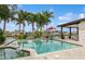 Inviting pool area with waterfront views, palm trees, and a comfortable seating, creating an ideal retreat at 1960 Kansas Ne Ave, St Petersburg, FL 33703