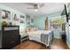 Comfortable bedroom with wood floors, gallery wall, and a window letting in natural light at 1983 Seton Dr, Clearwater, FL 33763