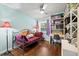 Relaxing bedroom offering natural light, wood floors, and decor shelving for storage at 1983 Seton Dr, Clearwater, FL 33763