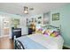 Charming bedroom with wood floors, decorative artwork, and soft, colorful accents at 1983 Seton Dr, Clearwater, FL 33763