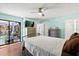 Bright bedroom with a ceiling fan, wood floors, and a sliding glass door to the outside at 1983 Seton Dr, Clearwater, FL 33763
