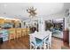 Inviting dining area adjacent to kitchen, featuring a unique starburst chandelier and sliding glass doors at 1983 Seton Dr, Clearwater, FL 33763