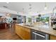 Spacious kitchen island with granite countertop, pendant lighting, and seating for casual dining at 1983 Seton Dr, Clearwater, FL 33763
