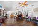 Open-concept living room with hardwood floors, decorative ceiling fans, and abundant natural light at 1983 Seton Dr, Clearwater, FL 33763
