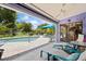 Inviting patio area with views of the pool, backyard, and tropical landscaping at 1983 Seton Dr, Clearwater, FL 33763