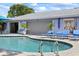 Relaxing pool area with lounge chairs, sunbeds, and access to the home's interior, for ultimate comfort and enjoyment at 1983 Seton Dr, Clearwater, FL 33763