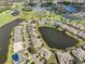 Stunning aerial view showcasing a residential area surrounded by lakes and a golf course, creating a picturesque setting at 2239 Sifield Greens Way # 84, Sun City Center, FL 33573