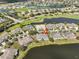 An aerial view of a waterfront neighborhood with mature landscaping, a golf course, and stunning views at 2239 Sifield Greens Way # 84, Sun City Center, FL 33573