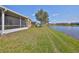 Lush backyard leading to a tranquil lake view, perfect for relaxation and outdoor enjoyment at 2239 Sifield Greens Way # 84, Sun City Center, FL 33573