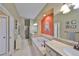 Spacious bathroom with soaking tub, neutral tile, and dual sink vanity at 2239 Sifield Greens Way # 84, Sun City Center, FL 33573