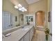 Well-lit bathroom with large mirror, extended vanity, and shower-tub combo at 2239 Sifield Greens Way # 84, Sun City Center, FL 33573