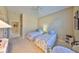 Bedroom featuring twin beds dressed in floral bedding, ceiling fan, and carpet at 2239 Sifield Greens Way # 84, Sun City Center, FL 33573