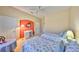 Inviting bedroom with vaulted ceiling and twin beds dressed in floral bedding at 2239 Sifield Greens Way # 84, Sun City Center, FL 33573
