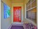 Inviting front entryway with a red front door, decorative welcome sign and a window at 2239 Sifield Greens Way # 84, Sun City Center, FL 33573
