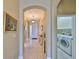 Inviting hallway leads to front door and features laundry room with appliances at 2239 Sifield Greens Way # 84, Sun City Center, FL 33573