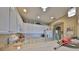 Well-lit kitchen features white cabinets, modern appliances, and ample countertop space for meal preparation at 2239 Sifield Greens Way # 84, Sun City Center, FL 33573
