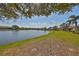 Scenic lake view surrounded by lush greenery and clear skies in a tranquil community at 2239 Sifield Greens Way # 84, Sun City Center, FL 33573