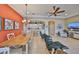 Open concept living area with dining space and a seamless view into the modern kitchen at 2239 Sifield Greens Way # 84, Sun City Center, FL 33573