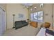 Bright living room with a ceiling fan, natural light, and comfortable green sofa at 2239 Sifield Greens Way # 84, Sun City Center, FL 33573