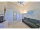 Comfortable room featuring a sofa, neutral walls, and multiple closets at 2239 Sifield Greens Way # 84, Sun City Center, FL 33573