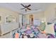 Spacious main bedroom with a white dresser and floral bedding at 2239 Sifield Greens Way # 84, Sun City Center, FL 33573