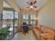 Bright home office featuring sliding glass doors, a comfortable sofa, and views of the outdoor landscape at 2239 Sifield Greens Way # 84, Sun City Center, FL 33573
