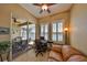 Comfortable home office with natural light, glass doors to a patio and a relaxing sofa with lake views at 2239 Sifield Greens Way # 84, Sun City Center, FL 33573
