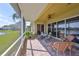 Screened in patio with brick flooring and a view of the lake at 2239 Sifield Greens Way # 84, Sun City Center, FL 33573