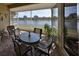 Screened in patio with brick flooring and a view of the lake at 2239 Sifield Greens Way # 84, Sun City Center, FL 33573