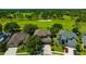 Aerial view of a home with well-maintained landscaping, mature trees, and access to the golf course at 23320 Dinhurst Ct, Land O Lakes, FL 34639
