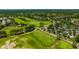Aerial view showcasing the golf course community, scenic views, and an assortment of beautiful homes at 23320 Dinhurst Ct, Land O Lakes, FL 34639
