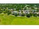 An aerial view of a community with lush trees, manicured lawns and golf course views at 23320 Dinhurst Ct, Land O Lakes, FL 34639