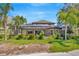 Home featuring a screened-in pool area surrounded by tropical landscaping for privacy and a serene outdoor space at 23320 Dinhurst Ct, Land O Lakes, FL 34639