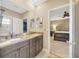 Bathroom featuring double vanity and access to bedroom at 23320 Dinhurst Ct, Land O Lakes, FL 34639