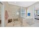 Bathroom with a glass shower enclosure, soaking tub, and tiled walls at 23320 Dinhurst Ct, Land O Lakes, FL 34639