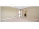 Spacious bedroom with neutral color scheme, carpet flooring, and two entryways to other rooms at 23320 Dinhurst Ct, Land O Lakes, FL 34639