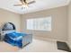 bedroom with carpet flooring, a ceiling fan, and a fun themed bed at 23320 Dinhurst Ct, Land O Lakes, FL 34639